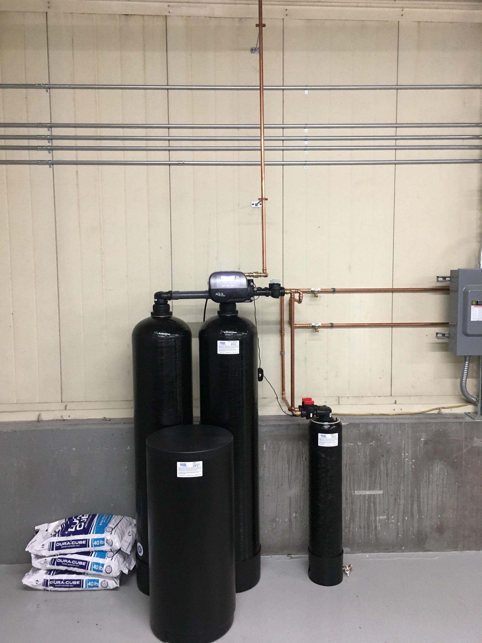 Twin water softener with high-capacity sediment filter to treat water being used in a manufacturing environment.