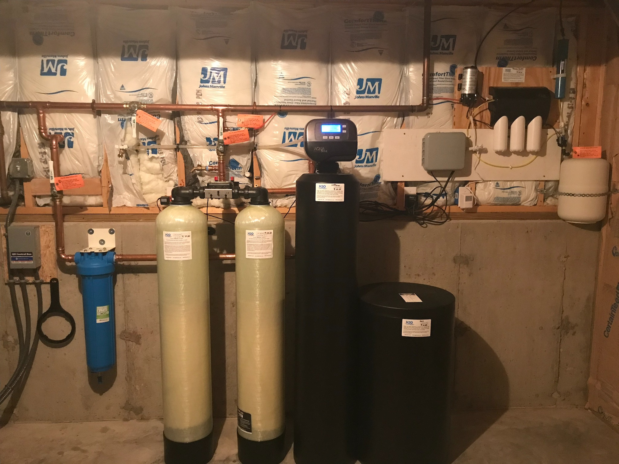 Twin (redundant) arsenic removal system with test ports and high efficiency 1 1/2 cubic feet Water Softener with 'big blue" graded density 5-micron sediment filter as well as a reverse osmosis purification system (on wall with 3 white housings with white storage tank) feeding a separate faucet upstairs at the kitchen sink.