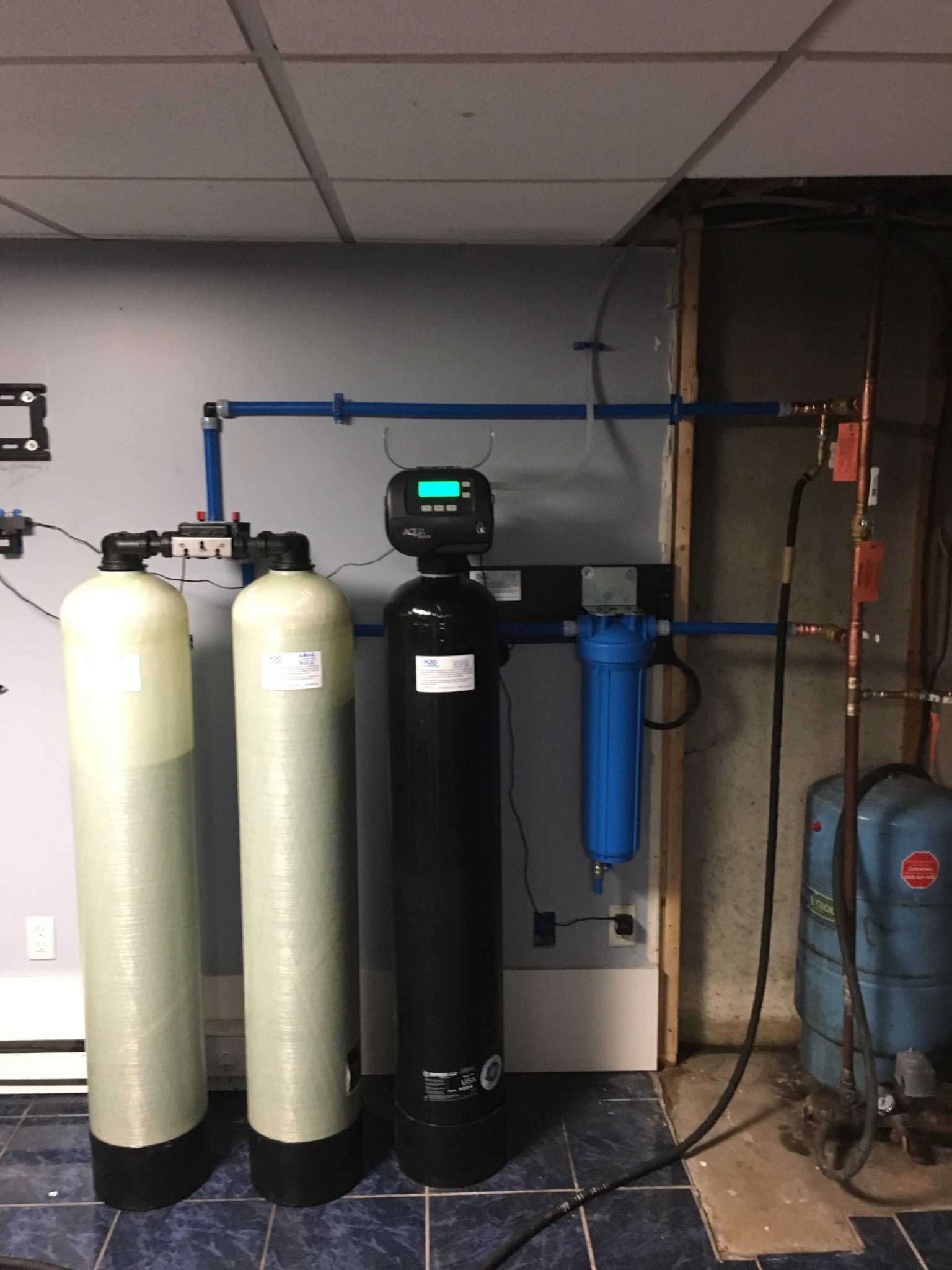 Whole house reverse osmosis filtration system installed to desalinate private well on coastal property experiencing saltwater intrusion.