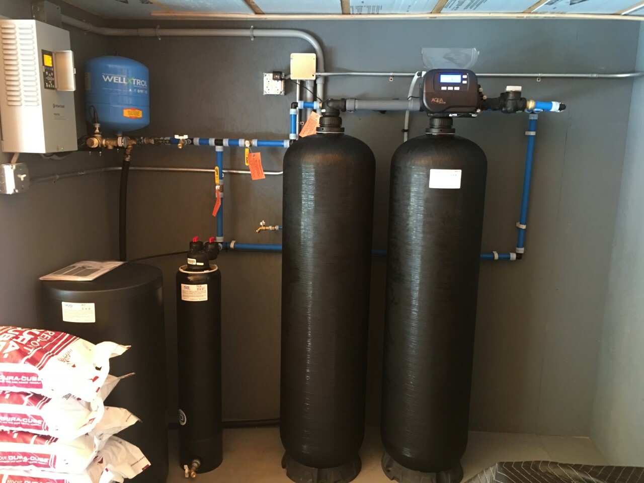 Irrigation - Rockport jpg Twin (redundant) arsenic removal system with test ports and high efficiency 1 1/2 cubic feet Water Softener with 'big blue" graded density 5-micron sediment filter as well as a reverse osmosis purification system (on wall with 3 white housings with white storage tank) feeding a separate faucet upstairs at the kitchen sink.